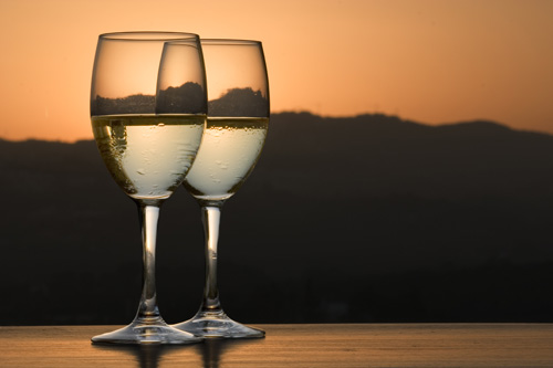 two glasses of white wine at sunset